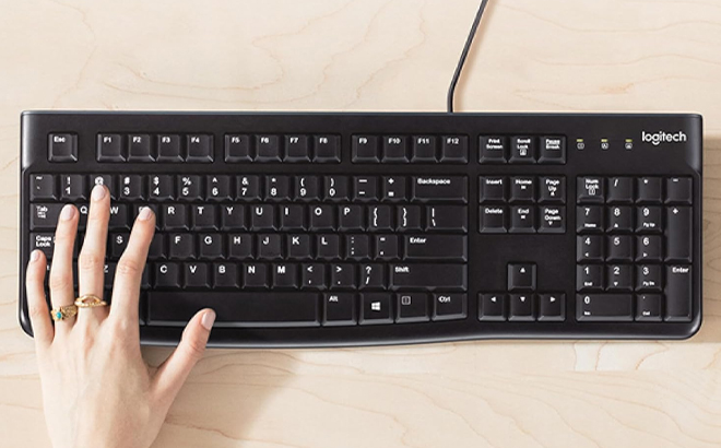 A Woman Typing on the Logitech Wired Keyboard