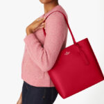 A Woman Wearing Kate Spade Jana Tote in Perfect Cherry