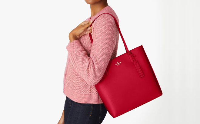 A Woman Wearing Kate Spade Jana Tote in Perfect Cherry