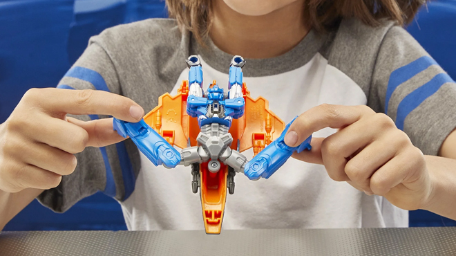 A child playing with Transformers Sentinel Prime Action Figure