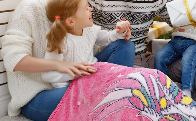 A girls using a Levens Glow in the Dark Unicorn Kids Blanket