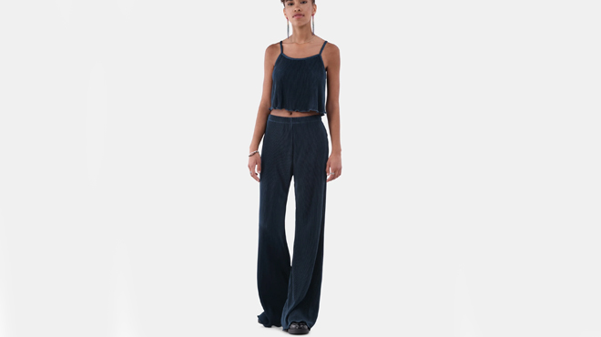 A lady wearing a No Boundaries Cami Pant Set in Gem Slate Color