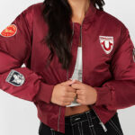 A lady wearing a True Religion Patched Bomber Jacket