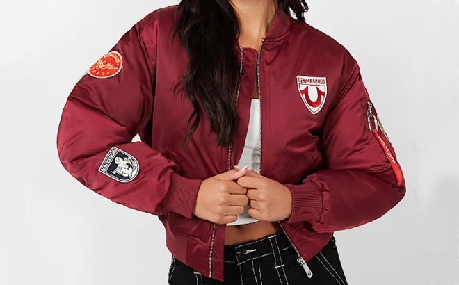 A lady wearing a True Religion Patched Bomber Jacket