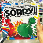 A person holding a Hasbro Classic Sorry Board Game 1