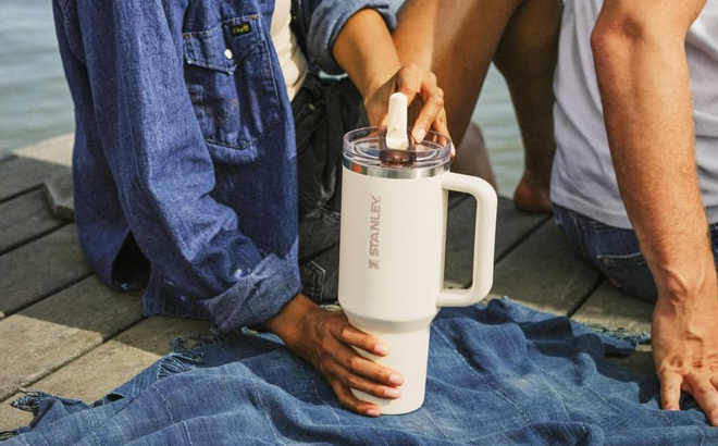 A person holding a Leakproof ProTour Flip Straw Tumbler