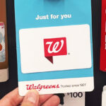 A person holding a Walgreens Gift Card