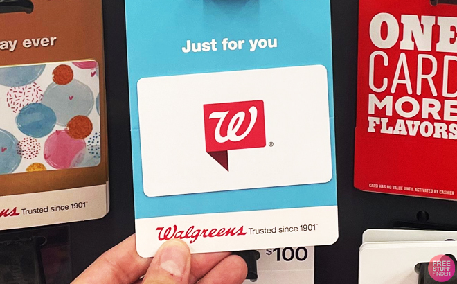 A person holding a Walgreens Gift Card