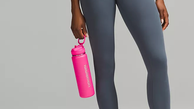 A person holding a pink Lululemon Sport Bottle 24 oz