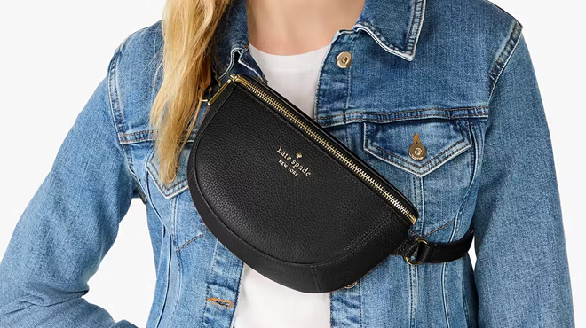 A person slinging a black Kate Spade Lena Bag