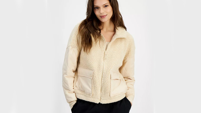 A person wearing Hippie Rose Juniors Quilted Trim Sherpa Jacket