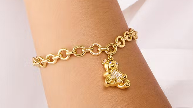 A person wearing a Kate Spade Teddy Bear Charm Bracelet