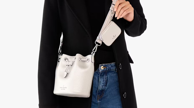 A person with a Kate Spade Rosie Metallic Small Bucket Bag