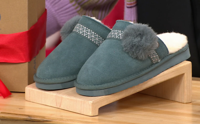 Bearpaw Linda Suede Slippers on a Product Stand