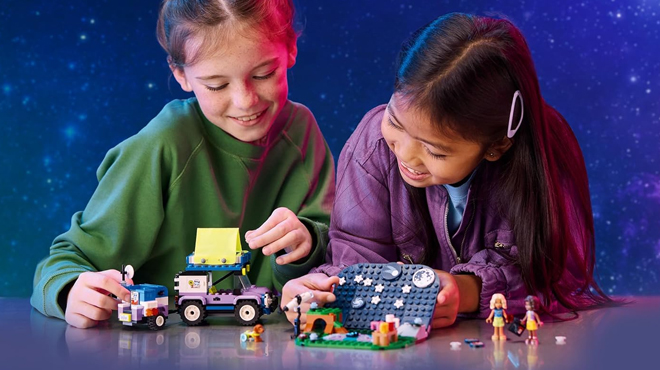 Girls playing with LEGO Friends Stargazing Camping Vehicle Adventure Toy