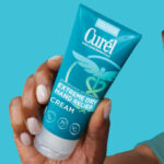 Hand holding Curel Dry Hand Relief Cream