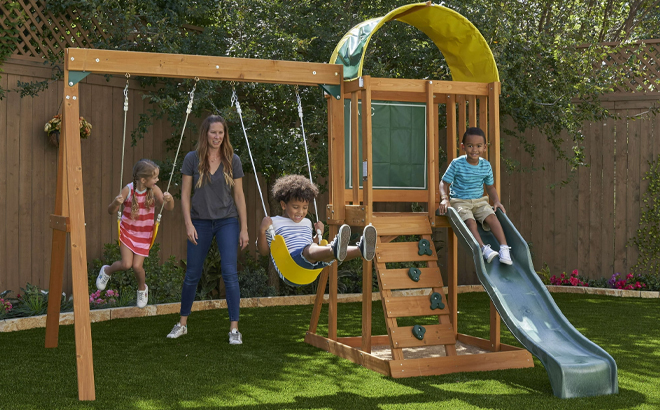 KidKraft Ainsley Wooden Outdoor Swing Set with Slide and Rock Wall