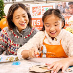 Mother and Daughter Participating in Home Depot Kids Workshop