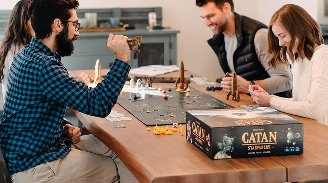 People Playing Catan Starfarers 2nd Edition Strategy Board Game