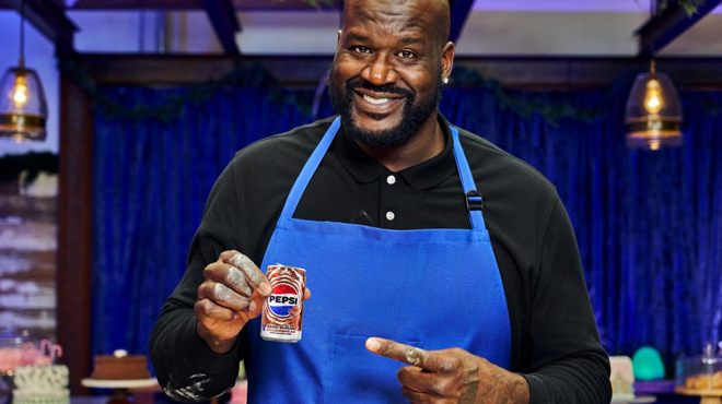 Shaquille ONeal holding a can of Pepsis Zero Sugar Gingerbread Mini Can