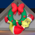 The Grinch Christmas Airblown Inflatable Hanging from a Wreath