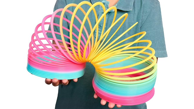 a Kid Holding Just Play Giant Slinky the Original Walking Spring Toy