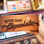 a Person Holding Too Faced Better Than Chocolate Eye Shadow Palette