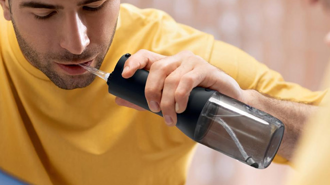 a Person Using Philips Sonicare Cordless Water Flosser