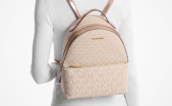 a Person Wearing Michael Kors Sheila Medium Two Tone Signature Logo Backpack