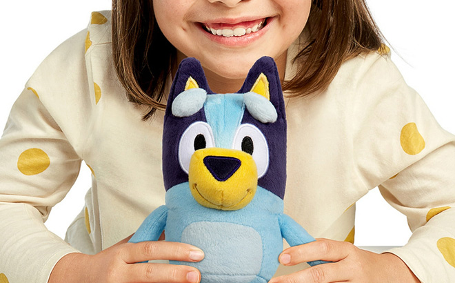 A Child Playing with a Bluey Plush