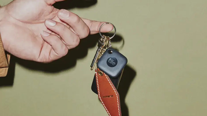 A Finger holding a Tile Mate Tracker