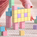 A Girl Playing with the Apluses Magnetic Blocks