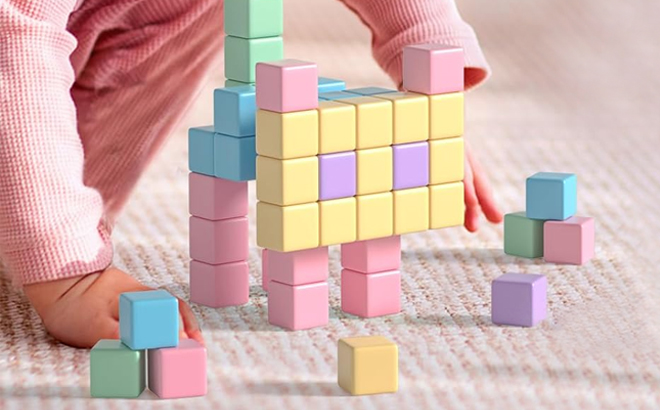 A Girl Playing with the Apluses Magnetic Blocks