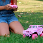 A Girl Playing with the Jada Toys Disney Minnie Mouse Jeep Wrangler Remote Control Car