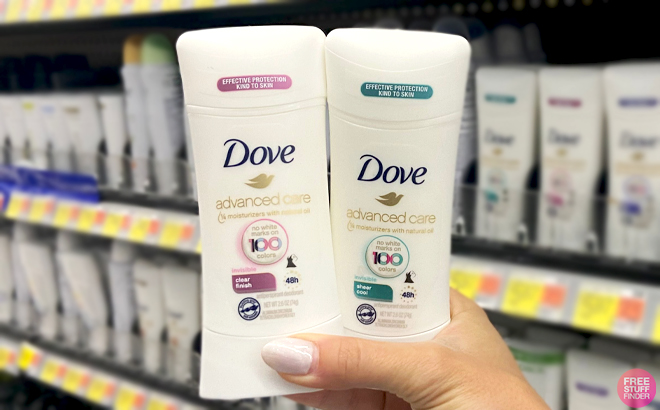 A Hand holding Dove Advanced Care Clear Finish Deodorant Stick and Dove Advanced Care Sheer Cool Deodorant Stick