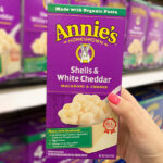 A Person Holding Annies White Cheddar Shells Mac and Cheese Macaroni and Cheese Dinner