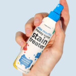 A Person Holding Miss Mouths Messy Eater Stain Treater Spray