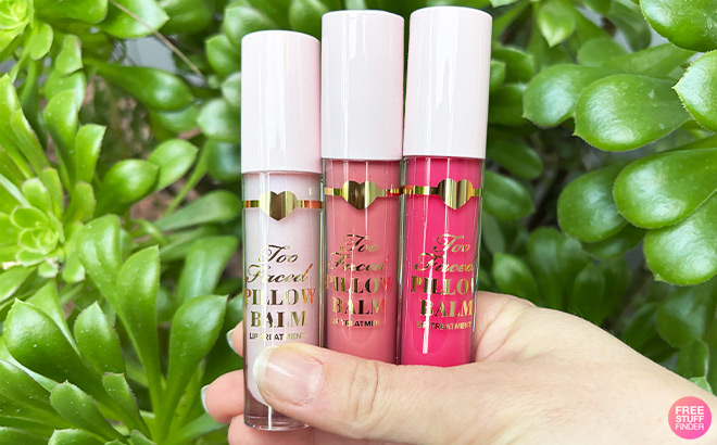 A Person Holding Three Tarte Balms