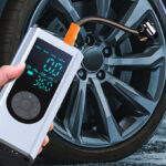 A Person Holding Tire Inflator Portable Air Compressor