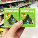 A Person Holding Two Hersheys Grinch Christmas Candy Gift Box