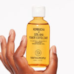 A Person Holding Youth To The People Kombucha 10 Power AHA Exfoliant