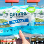 A Person Holding a 6 Pack of Gimme Sea Salt Organic Roasted Seaweed Sheets