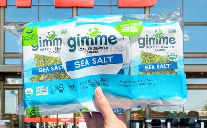 A Person Holding a 6 Pack of Gimme Sea Salt Organic Roasted Seaweed Sheets