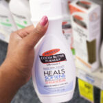 A Person Holding a Bottle of Palmers Cocoa Butter Formula Lotion