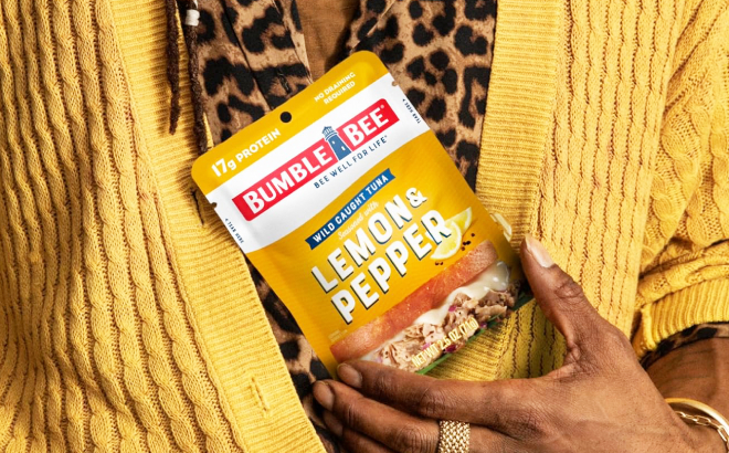 A Person Holding a Bumble Bee Lemon Pepper Seasoned Tuna Pouch