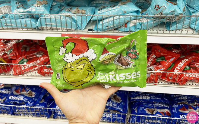 A Person Holding a Hersheys Kisses Grinch Christmas Candy Bag