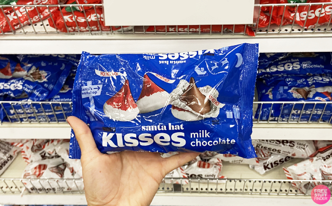 A Person Holding a Hersheys Kisses With Santa Hat Candy Bag