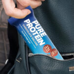 A Person Putting the Pure Protein Bar in Their Pocket