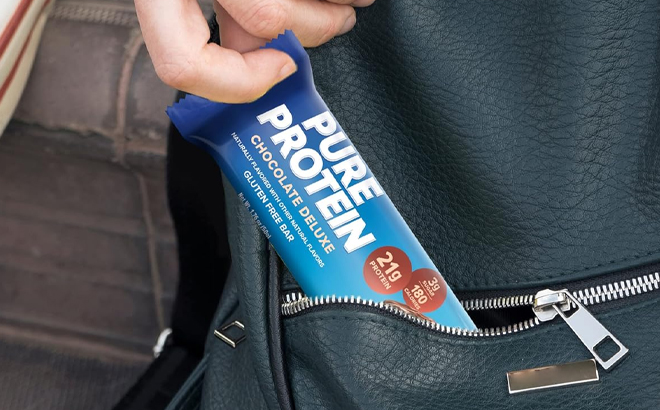 A Person Putting the Pure Protein Bar in Their Pocket