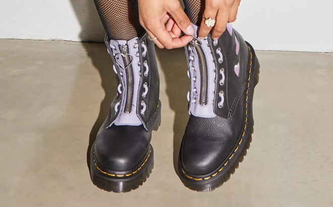 A Person Wearing Dr Martens 1460 Zip Heart Virginia Satin Lux Lace Up Boots